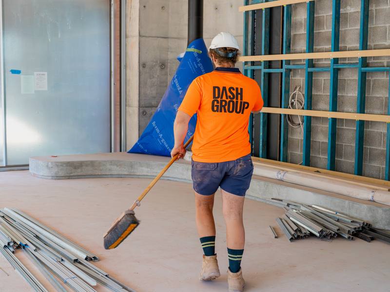 Dash Group labourer cleaning a construction site