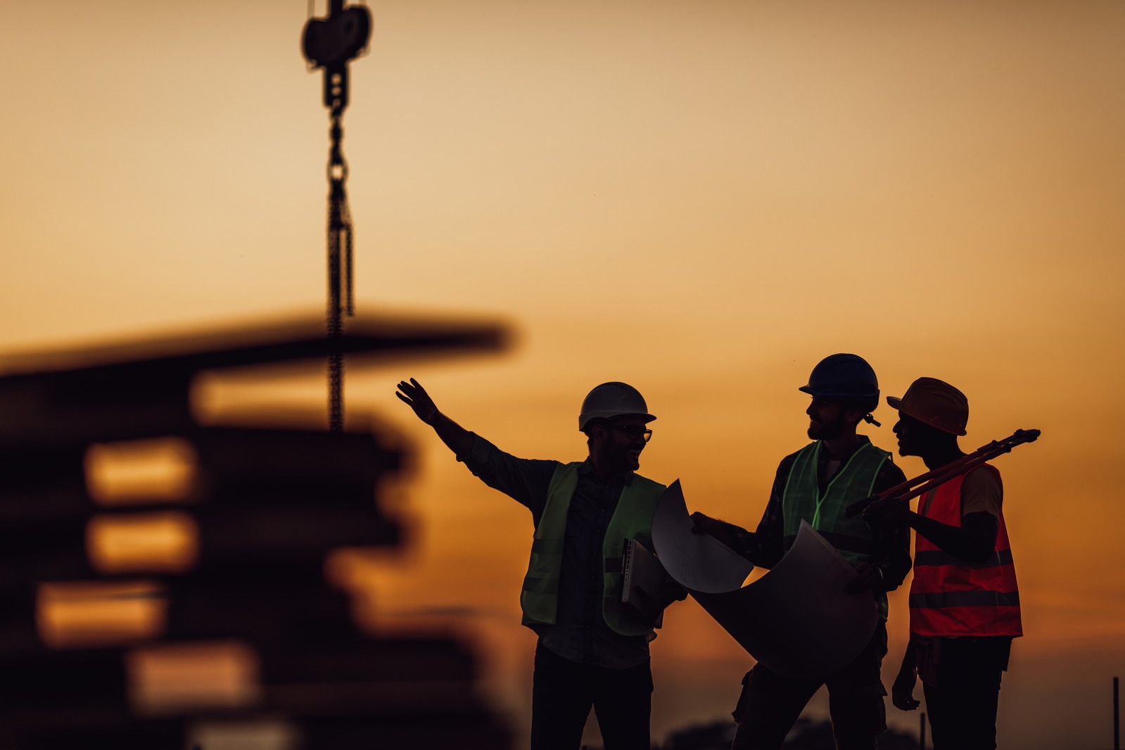 Construction crew on a building site at sunset